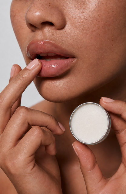 Model applying Tau Tau Skin Nourishing Lip Balm to lips — natural tallow lip balm in everyday use